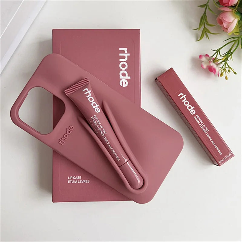 Pink lip case with lip balm and packaging on a white background