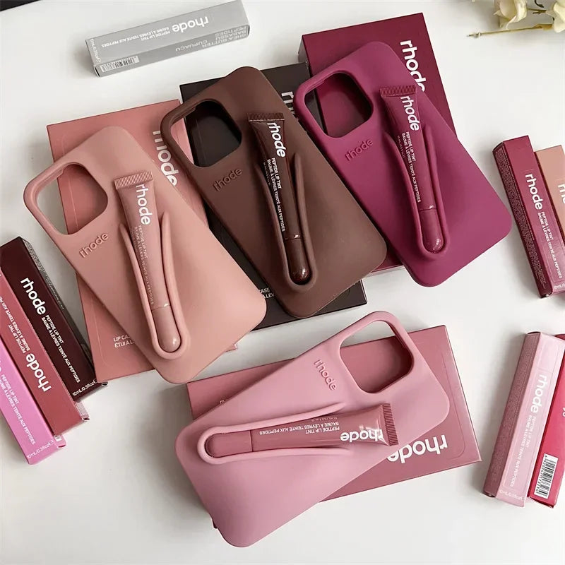 Collection of phone cases in various pink and brown colors with 'rhode' branding on a white background.