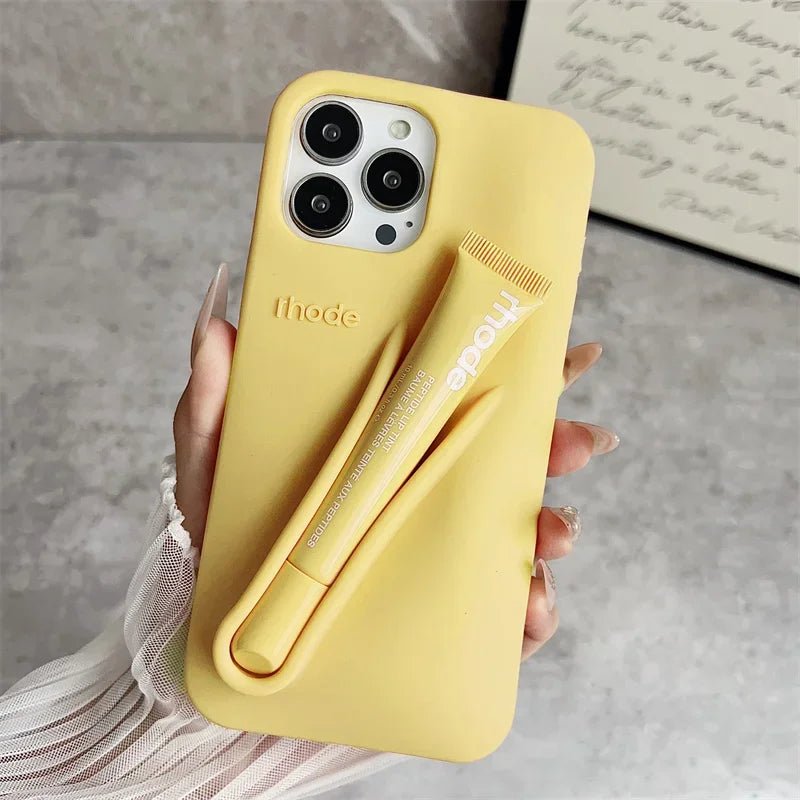 Yellow Rhode phone case with a pen holder held by a hand on a neutral background