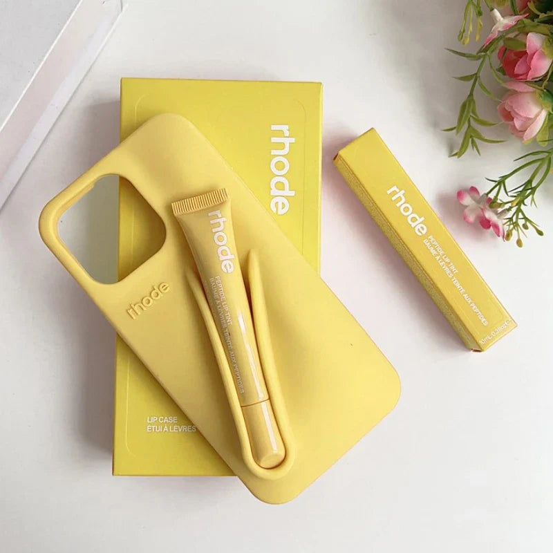 Yellow lip care products with 'rhode' branding on a white background