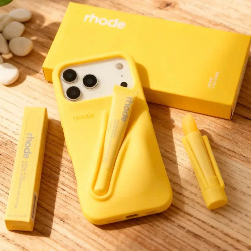 Yellow Rhode phone case with Rhode branding on a wooden surface