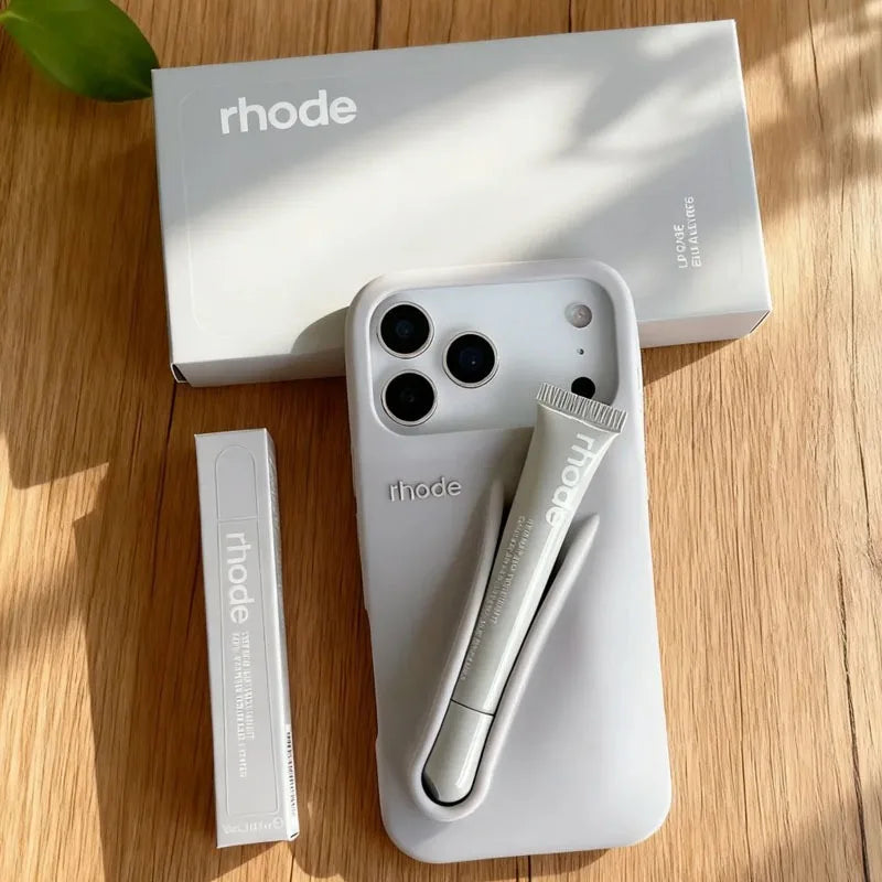 White phone case with 'rhode' branding on a wooden surface