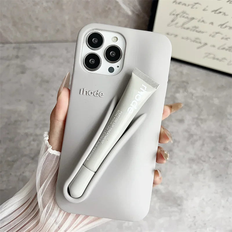 Phone case with built-in stylus held by a hand on a neutral background
