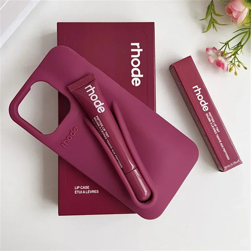 Pink Rhode lip case with pen and 'rhode' branding on a white background