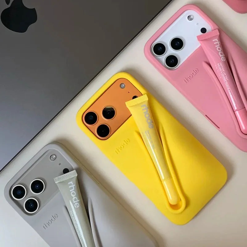 Three Rhode smartphones with colorful cases and accessories on a light surface